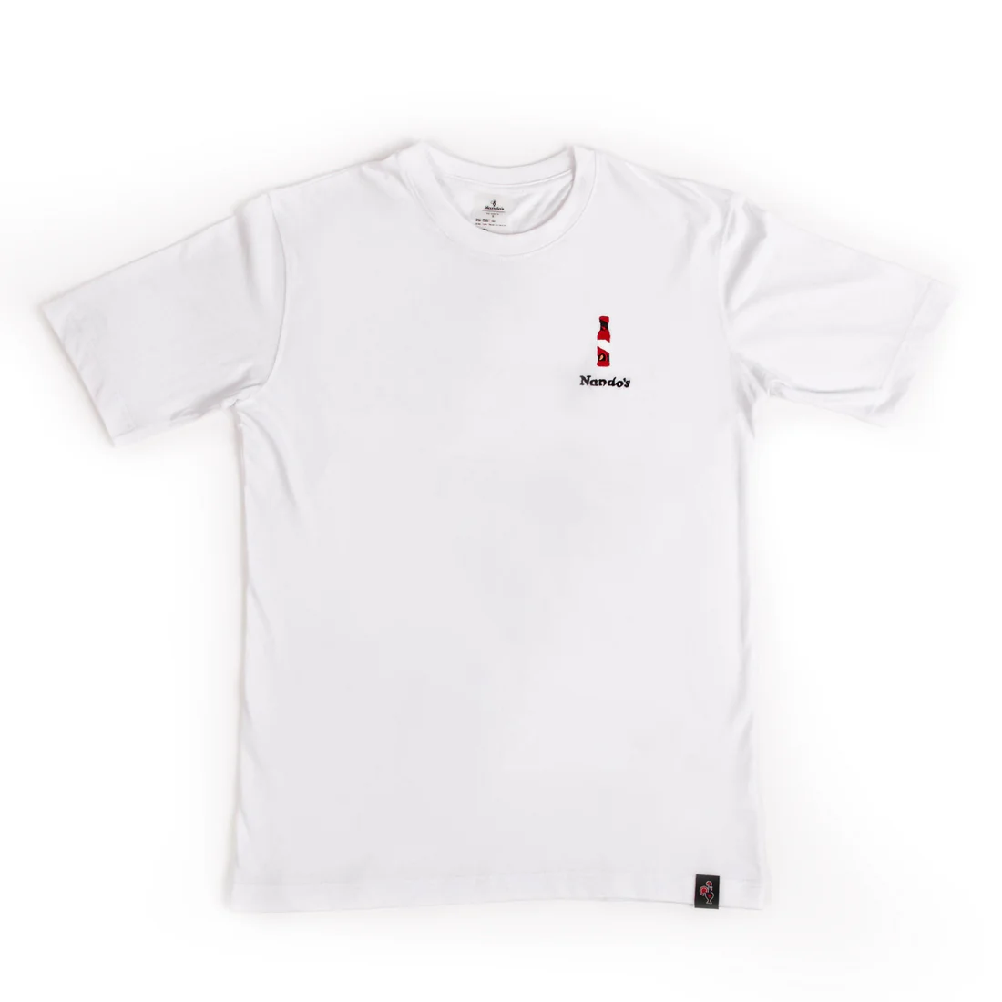 A white T-shirt with a small embroidered sauce bottle on the chest. Extra Hot is printed across the back in black.